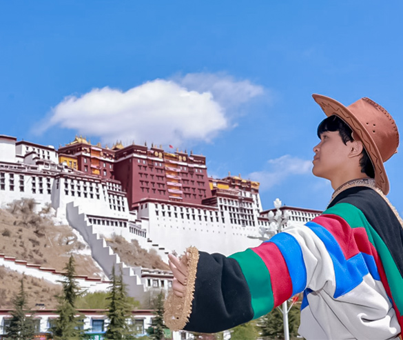 dressed in traditional tibetan dress and pose for photos with potala in lhasa