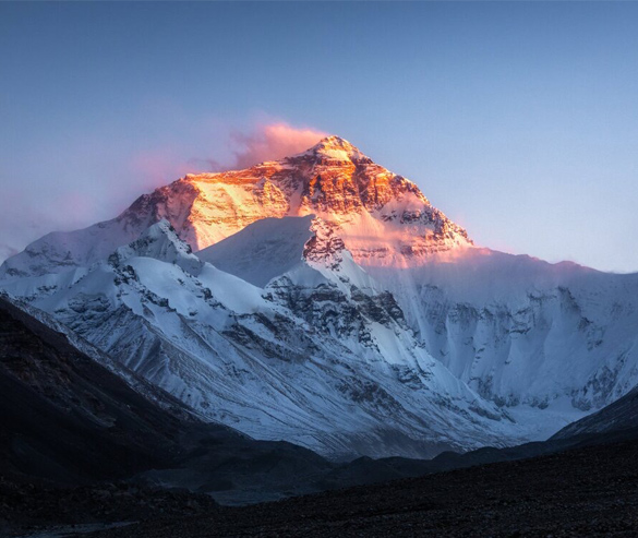 golden summit of north face of mt everest at sunset