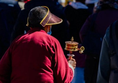 Traveler photo: On the Barkhor Street pilgrimage circuit in Lhasa, Tibet, we captured a local Tibetan slowly walking while rotating a prayer wheel. (December 2025)