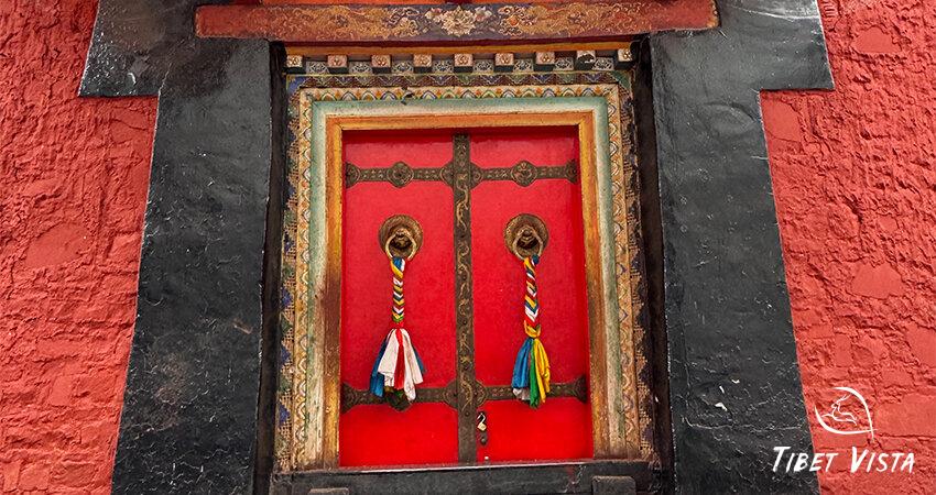 Ornately decorated red Tibetan door.